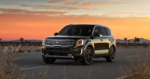 2020 Kia Telluride driving on a road at sunset