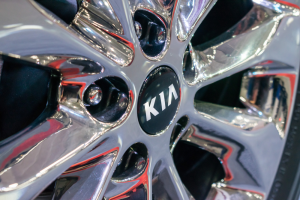 a chrome wheel with the kia emblem in the center