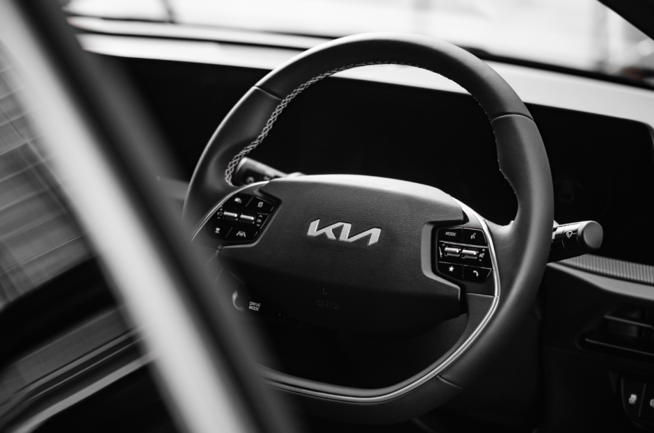 black interior of a kia with a black steering wheel